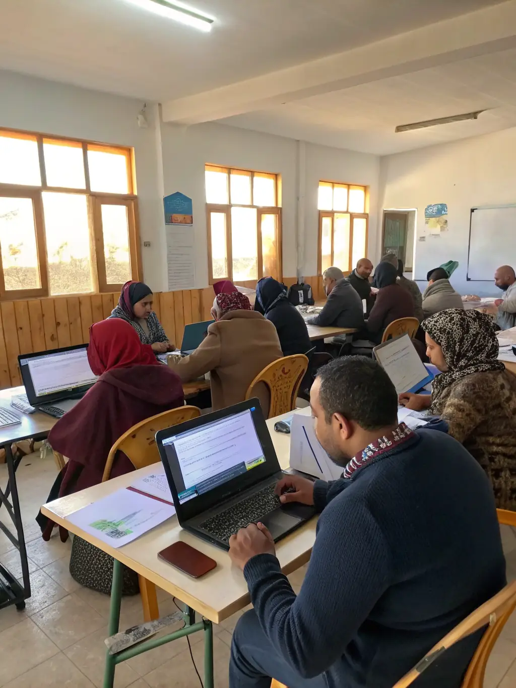 A photo of a workshop session at the 'UX Design Workshop' in Pretoria, South Africa, where participants are actively working on design prototypes.