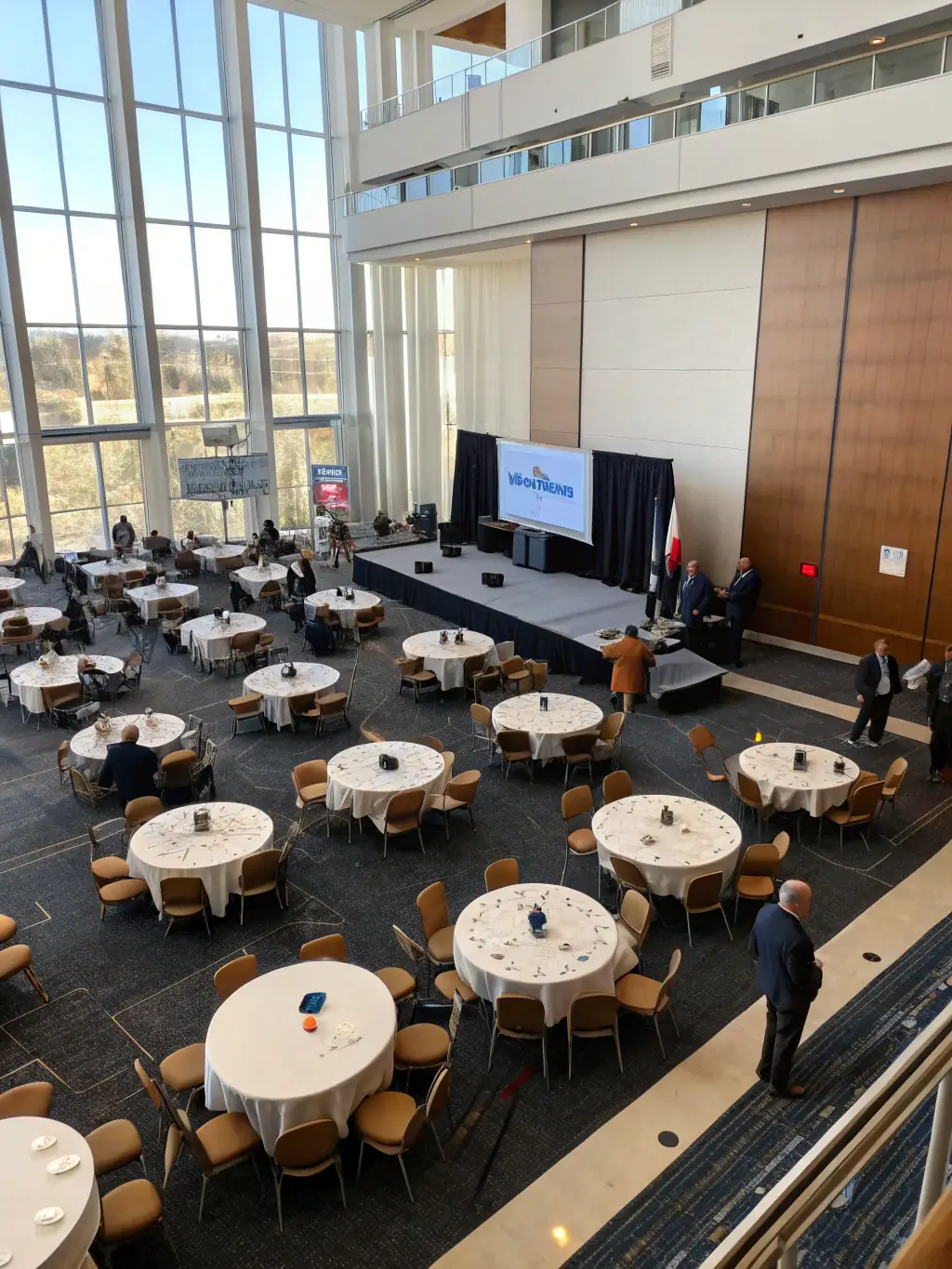 An aerial view of a conference setup in Pretoria, South Africa, showcasing the layout of booths, presentation stages, and networking areas. The image should provide an overview of the conference experience.