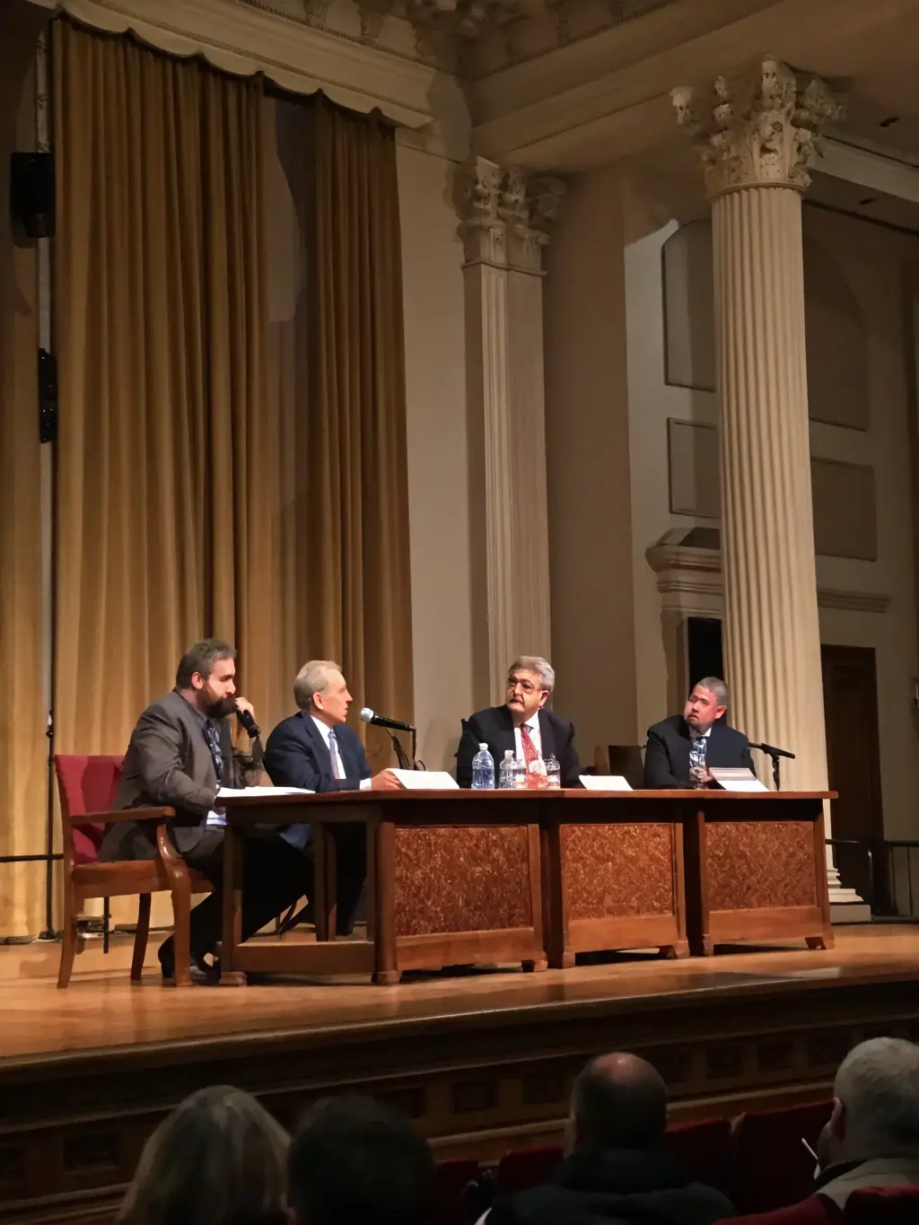 A dynamic image of a panel discussion at the 'Future of Design' conference in Durban, South Africa. The panelists are diverse and engaging, and the audience is attentive.